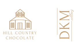 The logo for dkm county chocolate.