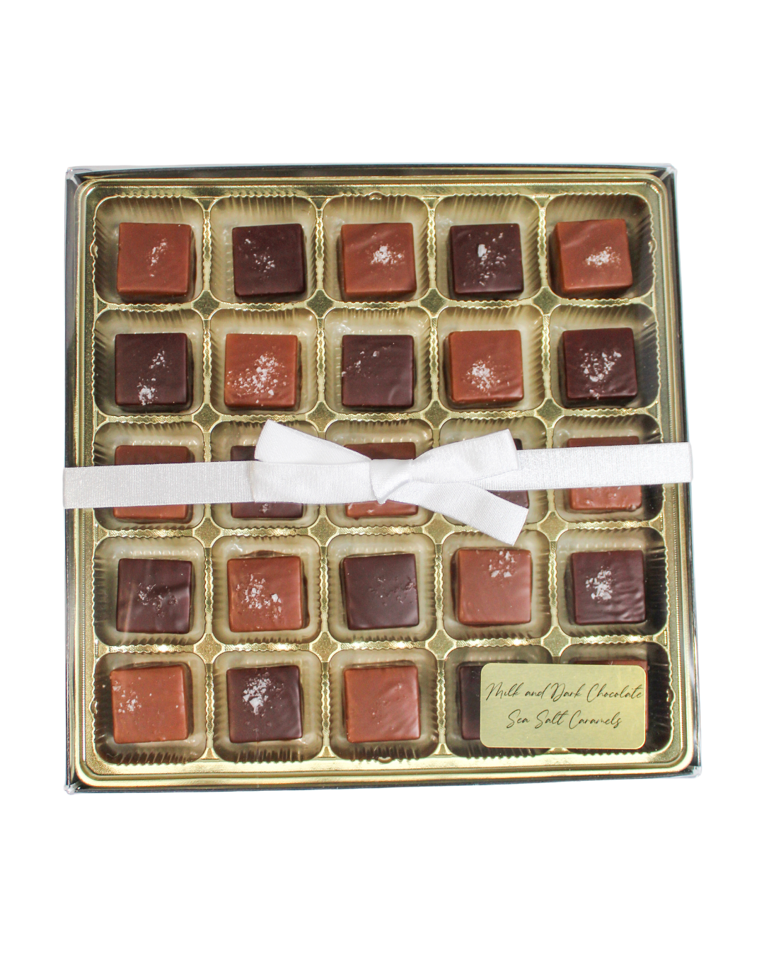 A box of Milk & Dark Chocolate Sea Salted Caramels tied with a white ribbon, featuring a small label for the mix.