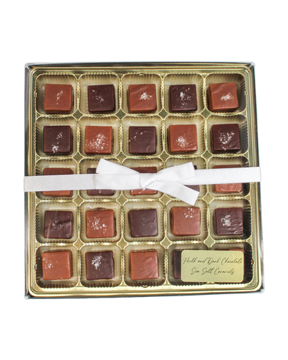 A box of Milk & Dark Chocolate Sea Salted Caramels tied with a white ribbon, featuring a small label for the mix.