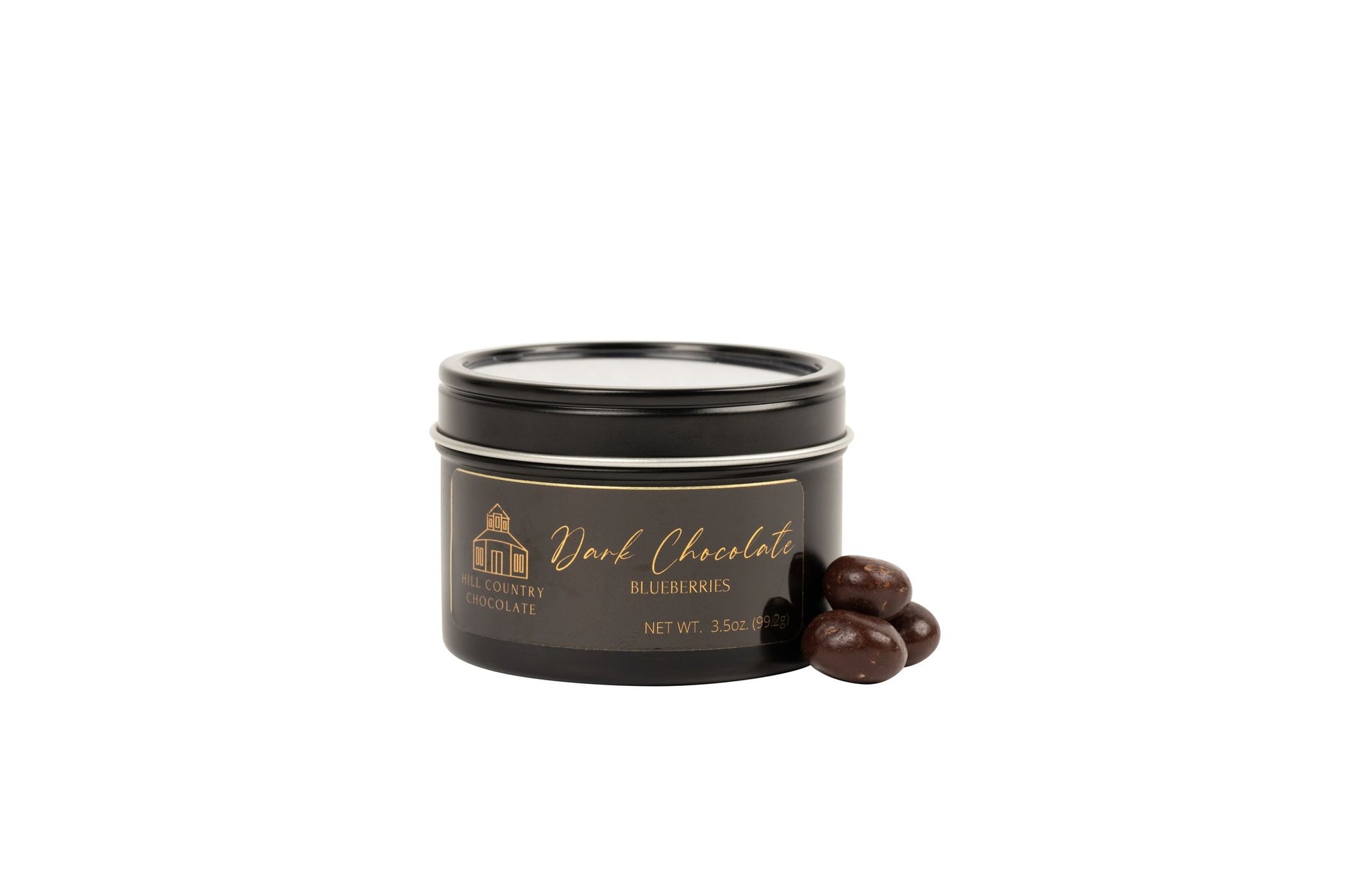 A Hill Country Chocolate of the Month Club tin in a black tin.
