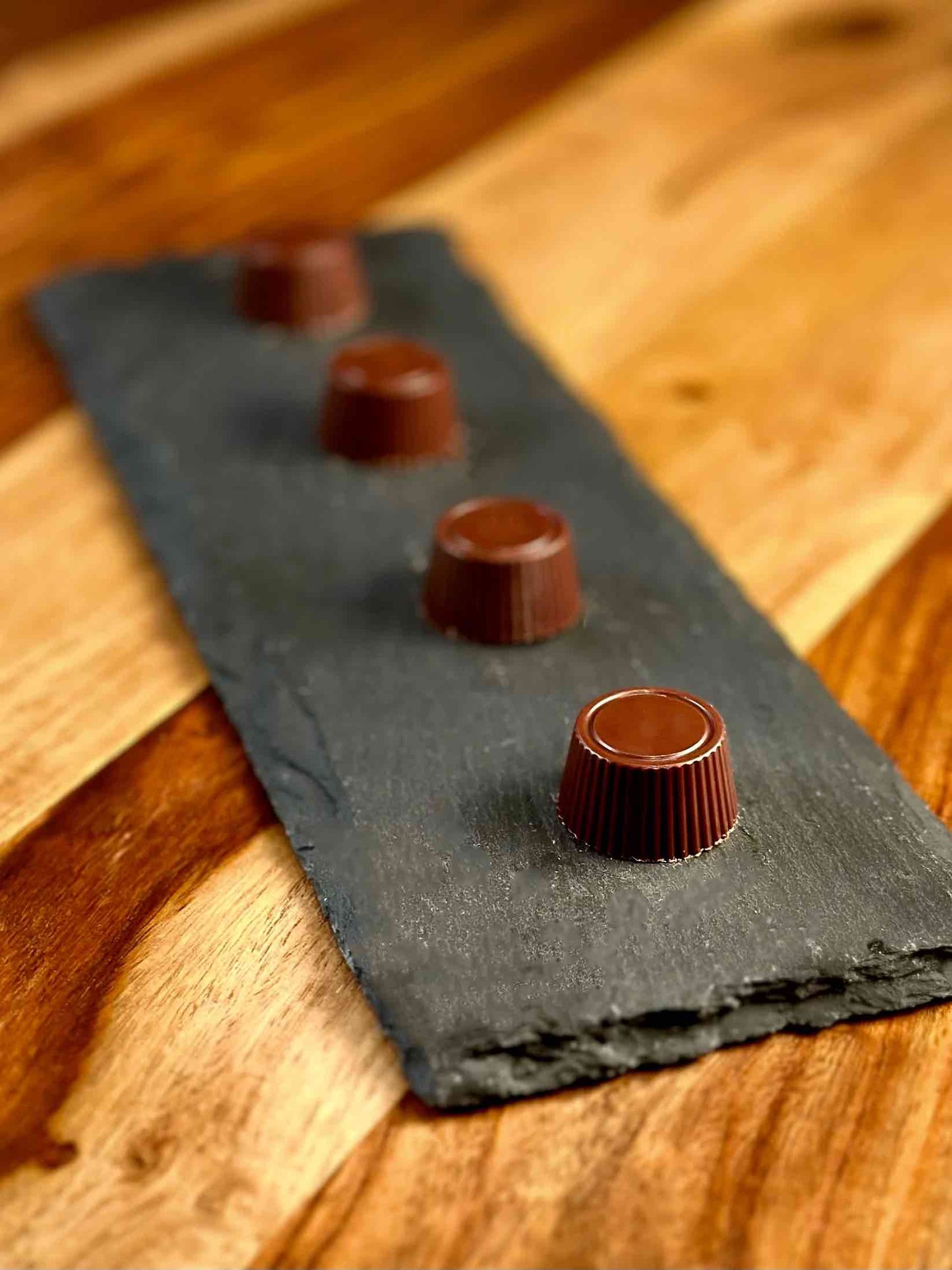 Hill Country Chocolate truffles on a slate board.