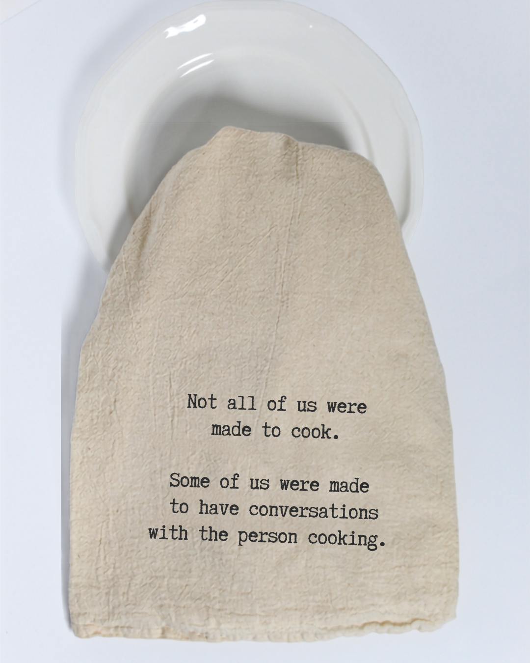 Bring a dash of humor to your kitchen with the Hill Country Chocolate “Not all of us were made to cook...” Tea Towel. Made from eco-friendly cotton in a warm beige tone, this charming towel features the witty phrase: “Not all of us were made to cook. Some of us were made to have conversations with the person cooking.”—perfect for displaying on a white plate or brightening up your kitchen décor.
