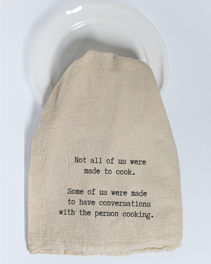 Bring a dash of humor to your kitchen with the Hill Country Chocolate “Not all of us were made to cook...” Tea Towel. Made from eco-friendly cotton in a warm beige tone, this charming towel features the witty phrase: “Not all of us were made to cook. Some of us were made to have conversations with the person cooking.”—perfect for displaying on a white plate or brightening up your kitchen décor.
