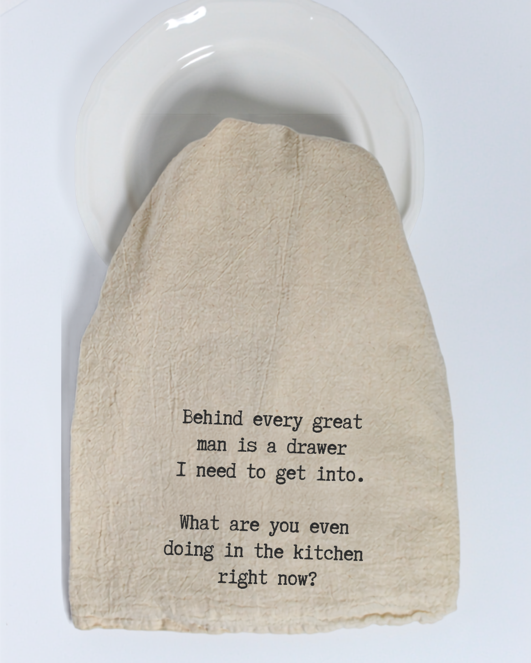 The “Behind every great man is...” Tea Towel by Hill Country Chocolate adds a playful touch to your kitchen with its witty black text on a beige cotton background, humorously referencing the need to get into a drawer behind someone. Made from natural materials, this eco-friendly kitchen towel combines practical use with lighthearted charm—perfect for any cooking space.