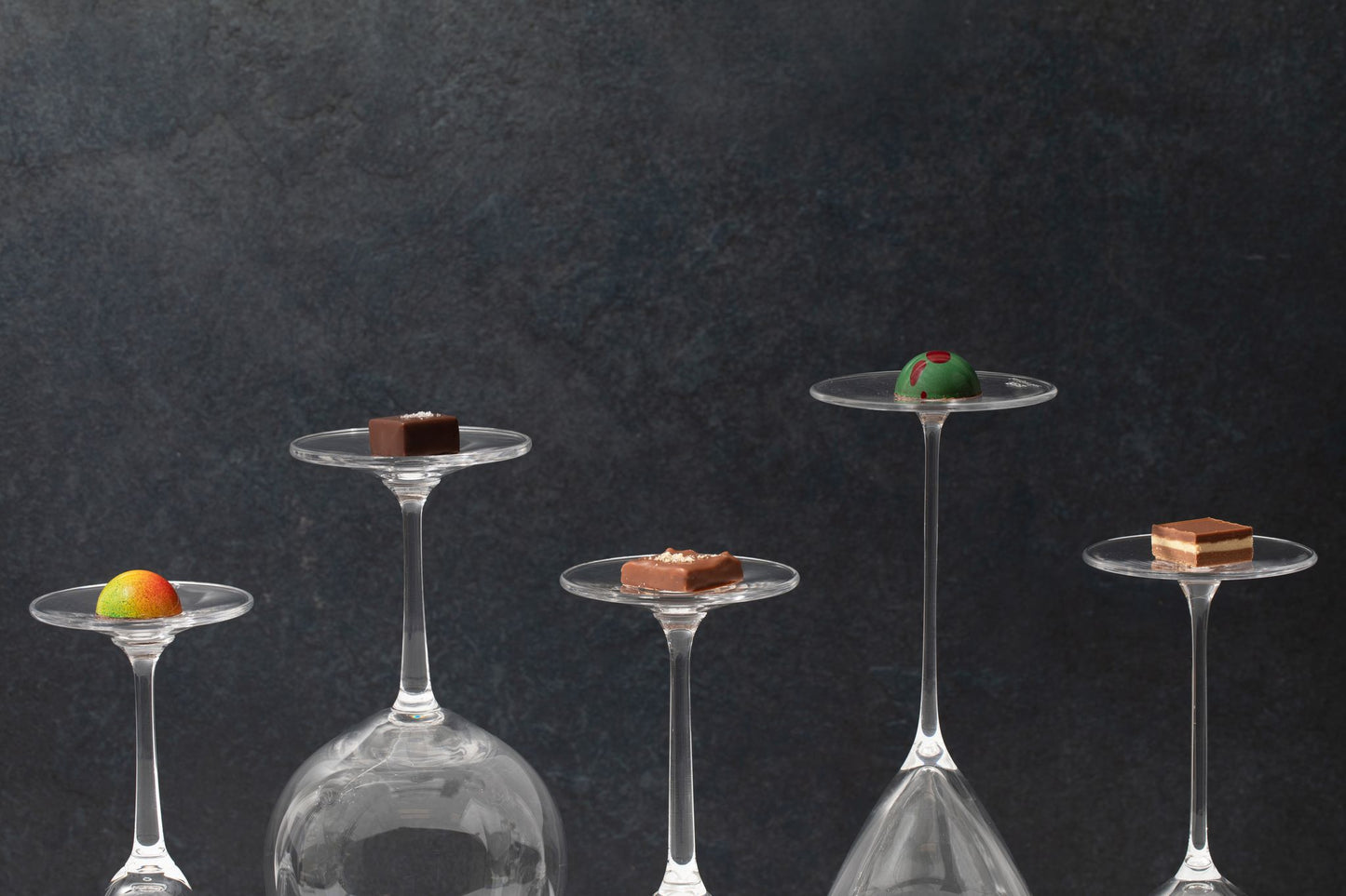 A group of Hill Country Chocolate wine glasses with Hill Country Chocolate chocolates in them.